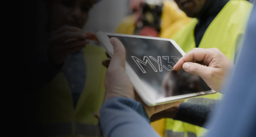 A view of a tablet with the MX3D white logo on it.